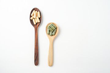 Herbal capsules in wooden spoon, Natural herbs, Alternative Medicine, Herbal supplement
