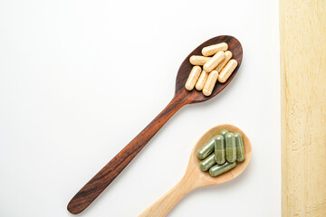 Herbal capsules in wooden spoon, Natural herbs, Alternative Medicine, Herbal supplement