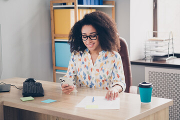 Photo of lovely adorable woman wear stylish clothes sitting chair using phone indoors workplace workshop