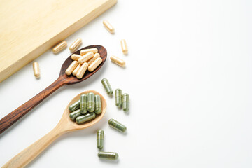 Herbal capsules in wooden spoon, Natural herbs, Alternative Medicine, Herbal supplement