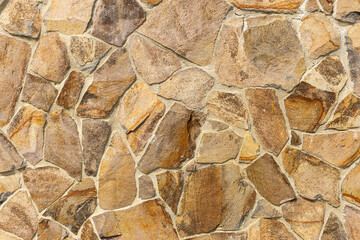 Processed stone old medieval stone wall texture in daylight. Banner background, backdrop or texture for 3D display