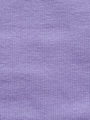 Footer fabric close-up. The texture of the fabric is purple, lavender in color. Sewing. Background.