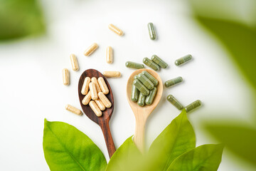 Herbal capsules in wooden spoon, Natural herbs, Alternative Medicine, Herbal supplement