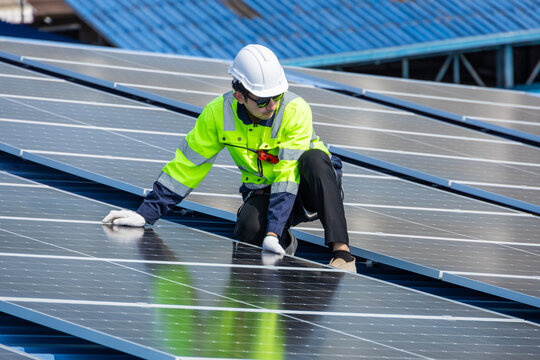 Professional Engineer Service Solar Panel. Worker Maintenance Cleaning Replacing Solar Panel. Solar photovoltaic panel system in Industry roof. Saving Energy with Clean Power.