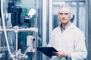 Scientist Medical Factory Staff Working in Science Lab. Medicine factory Technician Employee Check Care Products Quality in Sterilize Room Taking Note in Check list.