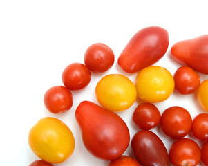 Mini black, red, and yellow tomatoes isolated on white