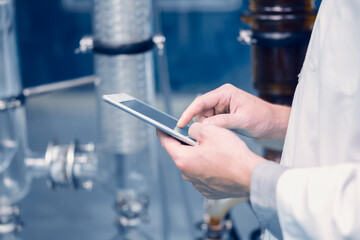 Scientist Medical Factory Staff Working in Science Lab. Medicine factory Technician Employee Check Care Products Quality in Sterilize Room with Tablet computer.