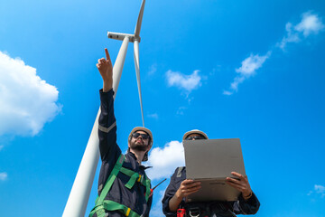 The engineering team joins hands with confidence after completing the inspection of the wind...