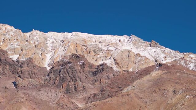 Snowy Himalayan mountain range as seen from Chandra Taal Lake in Spiti Valley, Himachal Pradesh, India. Snow covered Himalayan mountain peaks as seen from the glacial Chandratal lake in Spiti at Noon.
