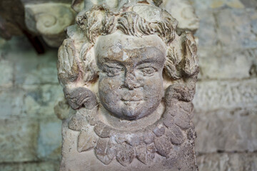 Close up of a carved stone angel head inside of the church in Vaison-la-Romaine, Provence, France, Europe
