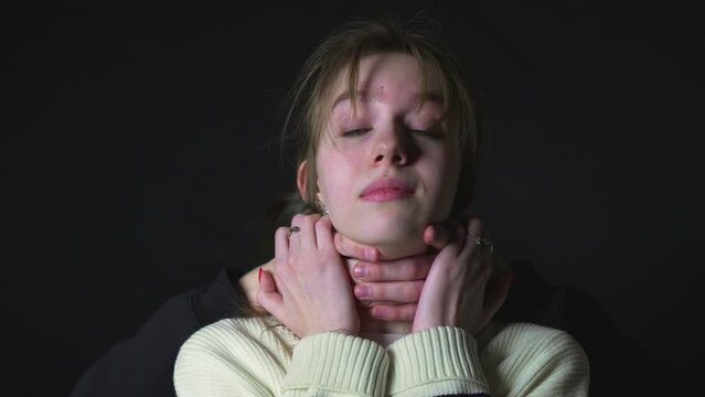 The maniac strangles the girl from behind. Threat to life.