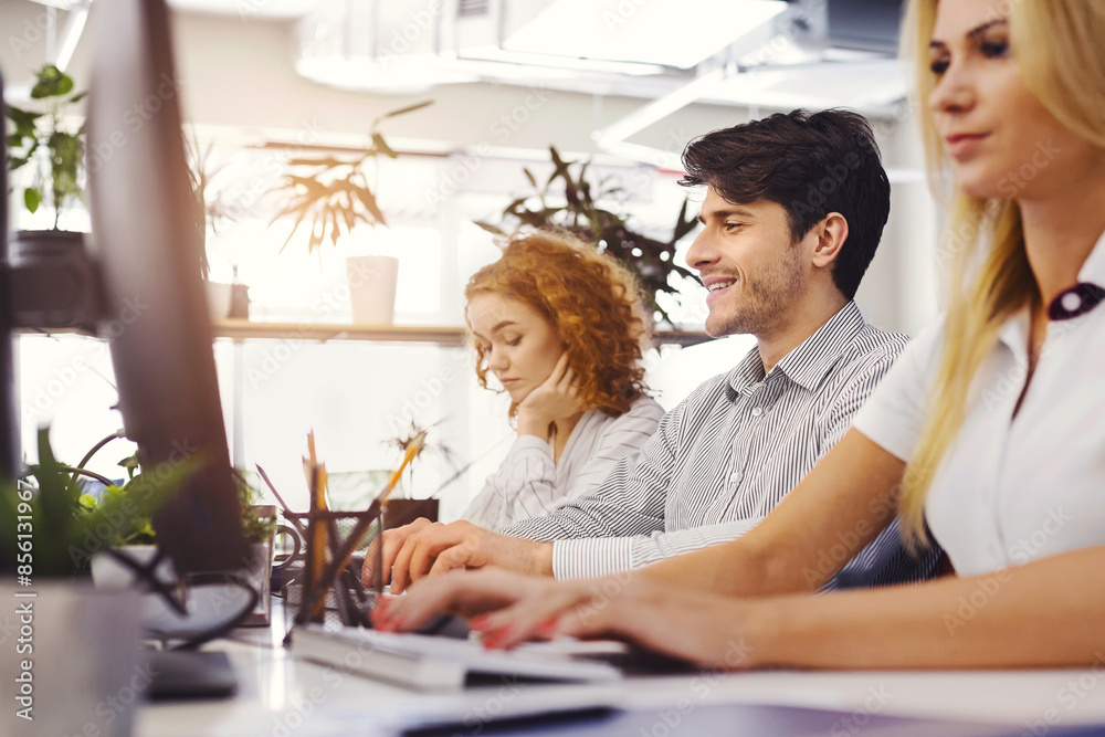 Poster dynamic office with modern equipment and focused workers: modern office setting filled with diligent