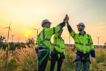 Team Engineers men and woman checking and inspecting on construction with sunset sky. people operation. Wind turbine for electrical of clean energy and environment. Industrial of sustainable. © ultramansk