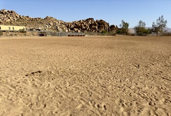 A picturesque horse coral at a desert ranch, surrounded by rugged terrain and cacti, embodies rustic charm and western spirit, offering a serene retreat for horse enthusiasts and adventurers alike.