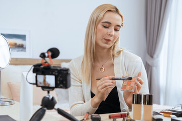 Young woman making beauty and cosmetic tutorial video content for social media. Beauty blogger...