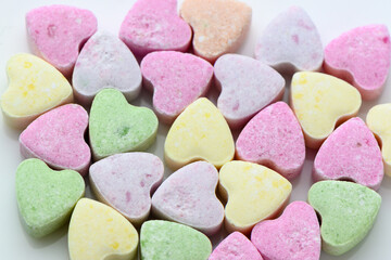 Closeup shot of a very small colorful candies in heart shape used for cakes decorations. 1