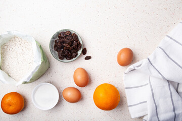 Fresh Eggs and Oranges on the Countertop with Baking ingredients