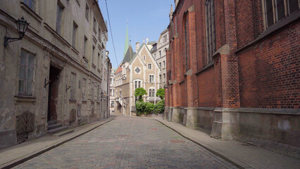 Street in the downtown of riga, it is cobblestone and the old buildings offer a picturesque view, 