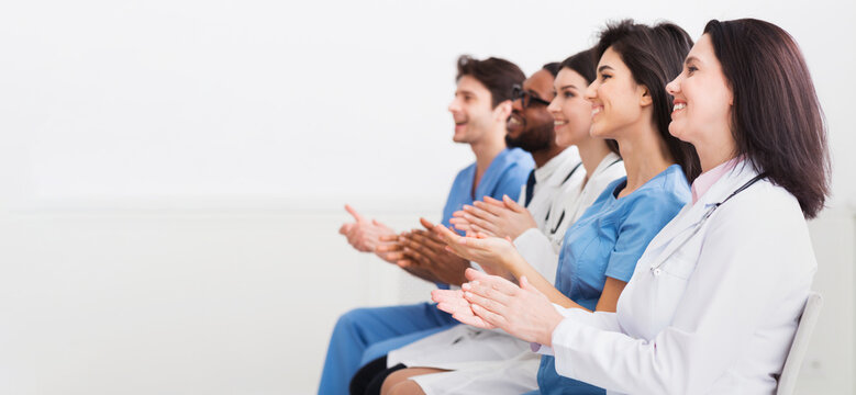 General Practitioners Applauding To Successful Lecturer, Sitting In Conference Room
