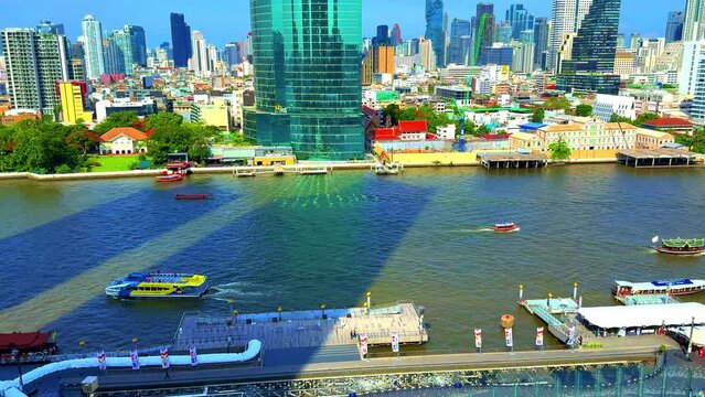 Chao Phraya River in BKK viewed from IconSiam Shopping Mall boats and ferries up and down the river and Bangkok high-rise buildings in the Background