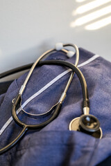 A doctor's stethoscope and hands.