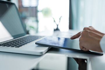 Businessman using digital tablet create business idea at home office.