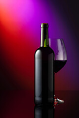 Glass and bottle of red wine.