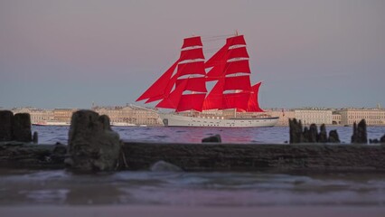 Saint Petersburg, Russia - June 01 2021, 4k, Panoramic view of sailing ship Russia with scarlet sails, in foreground remains of ancient corniche, the Neva River, white nights, St Petersburg, Russia 