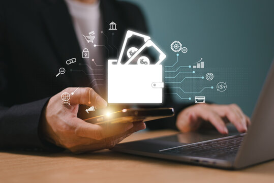 Wallet digital payment icon on internet mobile banking, online wallet business concept. Businessman hold mobile phone, computer laptop online money transaction application. Bank e-commerce investment