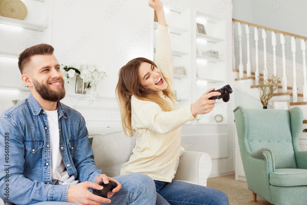 Poster a man and woman are actively playing a video game together, immersed in the virtual world on the scr