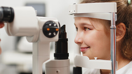 Eye iris and pupil macro. Reflected moving light rays into the child eye with zoom. Close up. The concept of ophthalmology and medicine. Medical attendance at the optometrist in a bright modern clinic