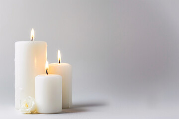 white candles on the white background with copy space