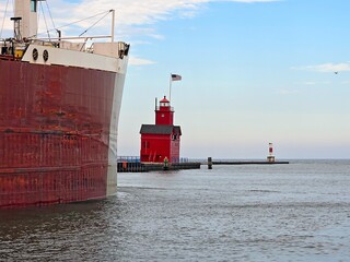 Close-up of a freighter leaving a harbor in Holland Michigan with Big Red lighthouse