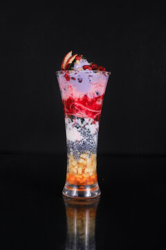 3 layered falooda with ice cream, cherry and strawberry on top