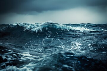A dramatic seascape with large waves crashing in a stormy ocean. The dark sky and water create a moody and powerful image.