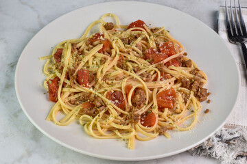 linquine  mixed with sausage and tomatoes