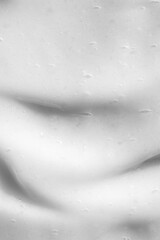 close-up of a smooth white cream texture, perfect for backgrounds in beauty and skincare presentations. This image highlights the cream's soft, luxurious consistency, ideal for cosmetic product market