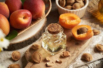 Apricot kernel oil in a glass bottle - natural cosmetic product and food