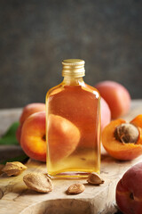 Apricot kernel oil in a glass bottle with copy space