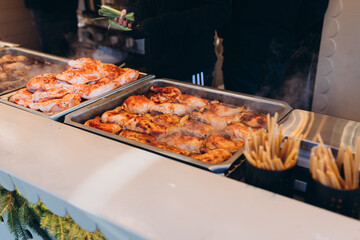Food festival with food stall kiosk, open-air outdoor fair market. Grilled Chicken. Takeaway food fair.