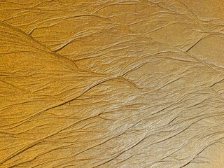Texture of water flowing on sand