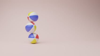 Three beach balls stacked on top of each other, balancing delicately against a clear background...