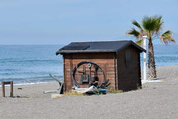 Deteriorated wooden hut on the beach sand