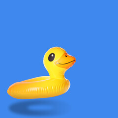 Stylish inflatable duck shaped ring in air on blue background