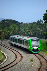 View of a passenger train moving in a rural or hilly area