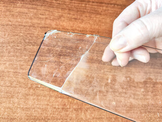 Removing Protective Film From a Cracked Screen. Peeling off a cracked screen protector from a phone
