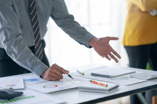 Business meeting with professional discussing charts, graphs, and reports. Teamwork, planning, and strategy development. Office environment.