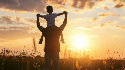 Fototapeta premium A father carrying his child on his shoulders at sunset in a golden field, symbolizing joy, connection, and the beauty of nature.