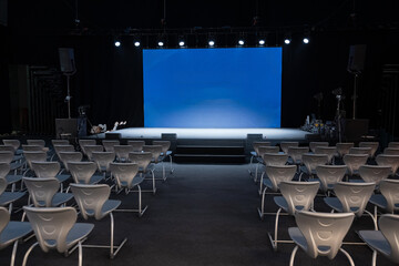 empty conference stage and a blank blue screen