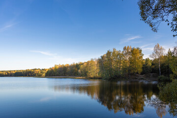 A calm lake with trees in the background